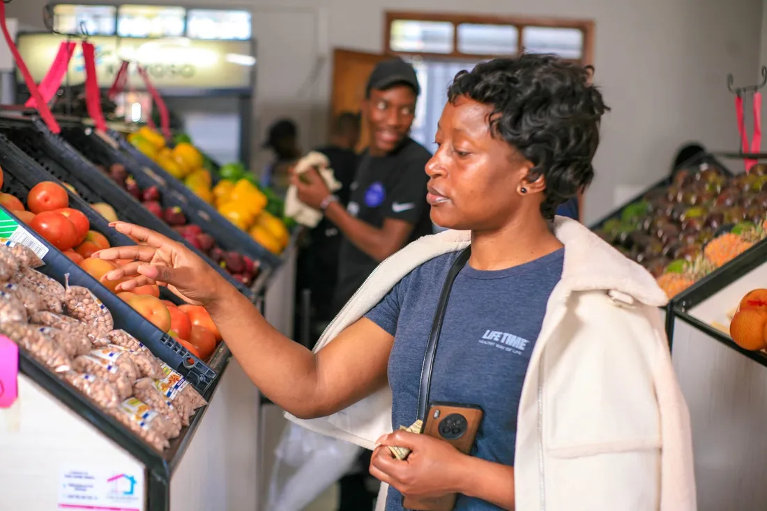 A customer shopping for fresh produce at 8020 Market