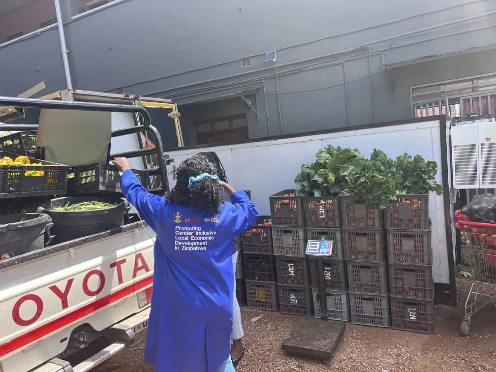 8020 Market staff loading fresh produce onto a delivery truck